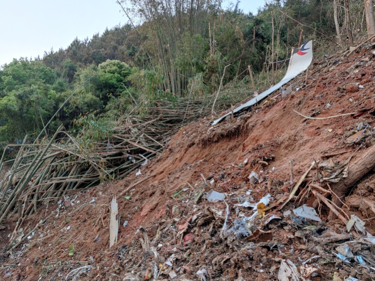 Metal debris in the white colors of China Eastern strewn on the hillside in southern China 