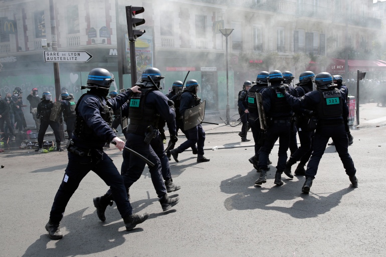Riot police officers take positions during a May Day demonstration march from Republique, Bastille to Nation, in Paris, France, Sunday, May 1, 2022 [Lewis Joly/AP]