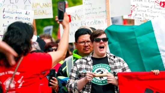 A Starbucks Workers Union member yells as the May Day march makes it way to Westlake Park in Seattle.(AP)