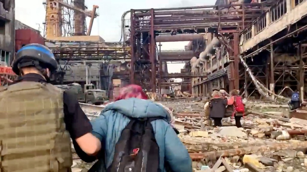 Azov regiment members walk with civilians during UN-led evacuations from the sprawling Azovstal steel plant, after nearly two months of siege warfare on the city by Russia during its invasion, in Mariupol, Ukraine in this still image from handout video released May 1, 2022 . 