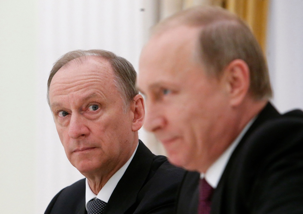 Russian Security Council Secretary Nikolai Patrushev (L) looks at President Vladimir Putin during a meeting with the BRICS countries' senior officials in charge of security matters at the Kremlin in Moscow on May 26, 2015.