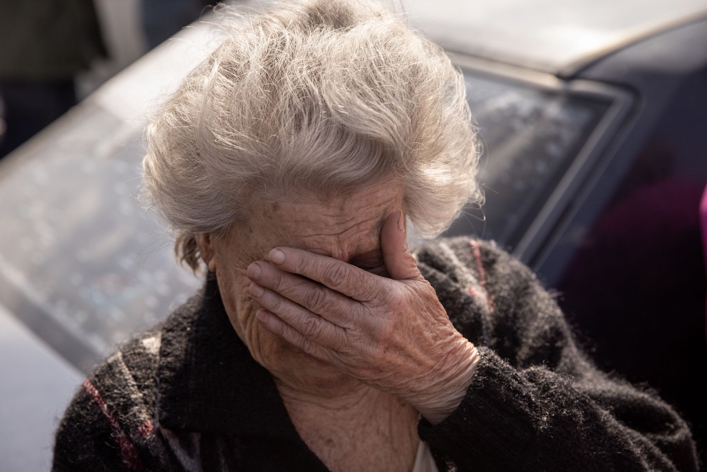 Dina, 81 of Mariupol reacts after arriving by car at an evacuation point for people fleeing Mariupol, Melitopol and the surrounding towns under Russian control on May 02, 2022 in Zaporizhzhia, Ukraine. 