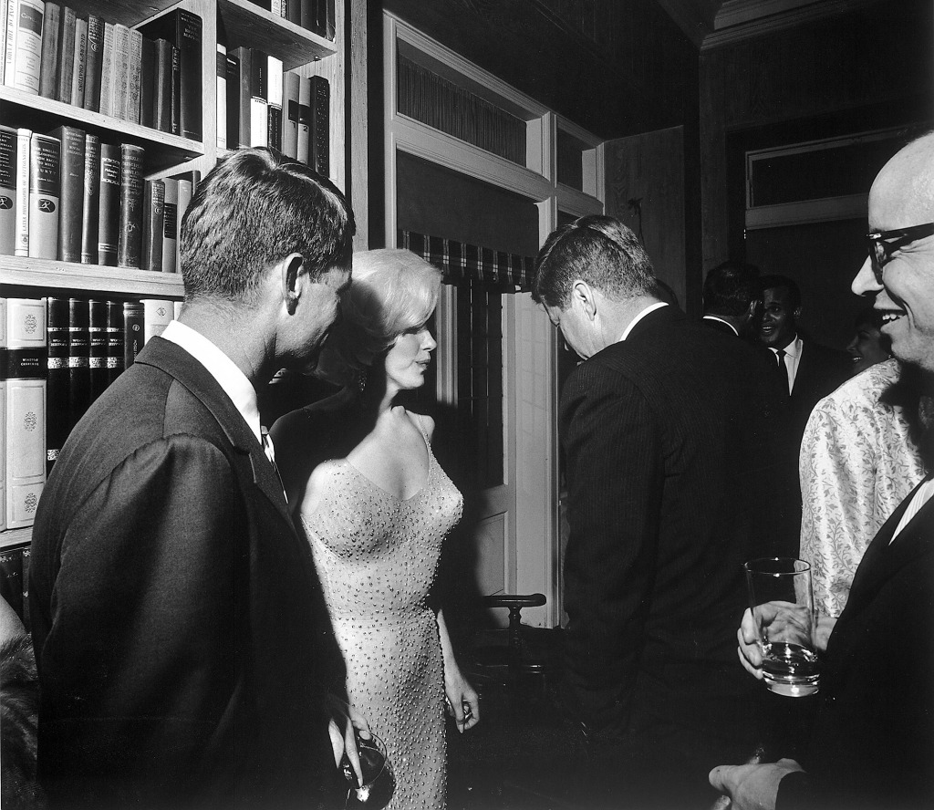 American actress Marilyn Monroe stands between Robert Kennedy (left) and John F. Kennedy, New York, New York, May 19, 1962.